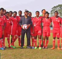 kids with coach in soccer field