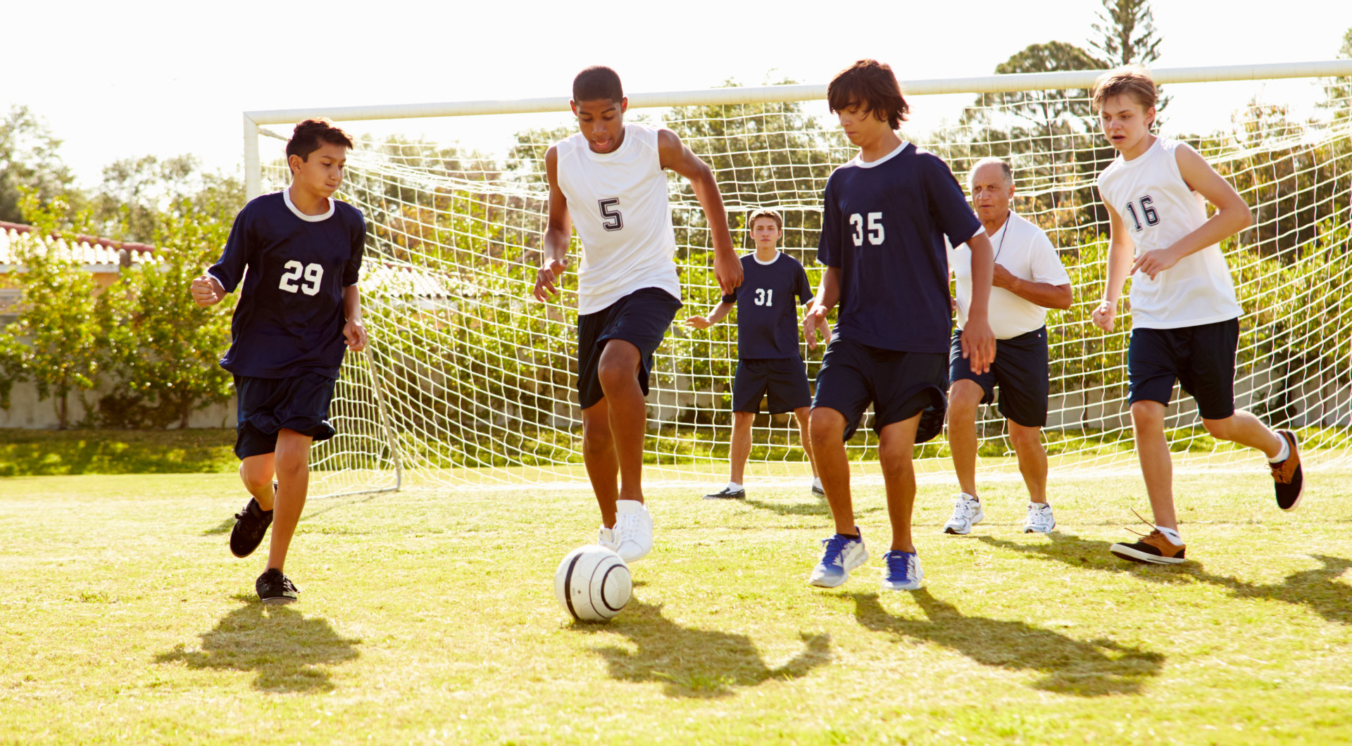 group of adult playing soccer