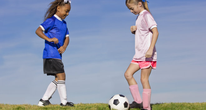 two kids playing soccer