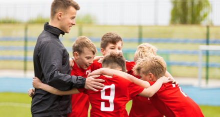 kids and coach talking