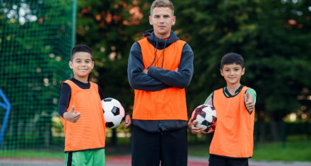 kids and coach looking at the camera