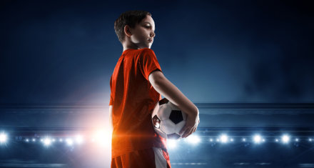 kid holding soccer ball